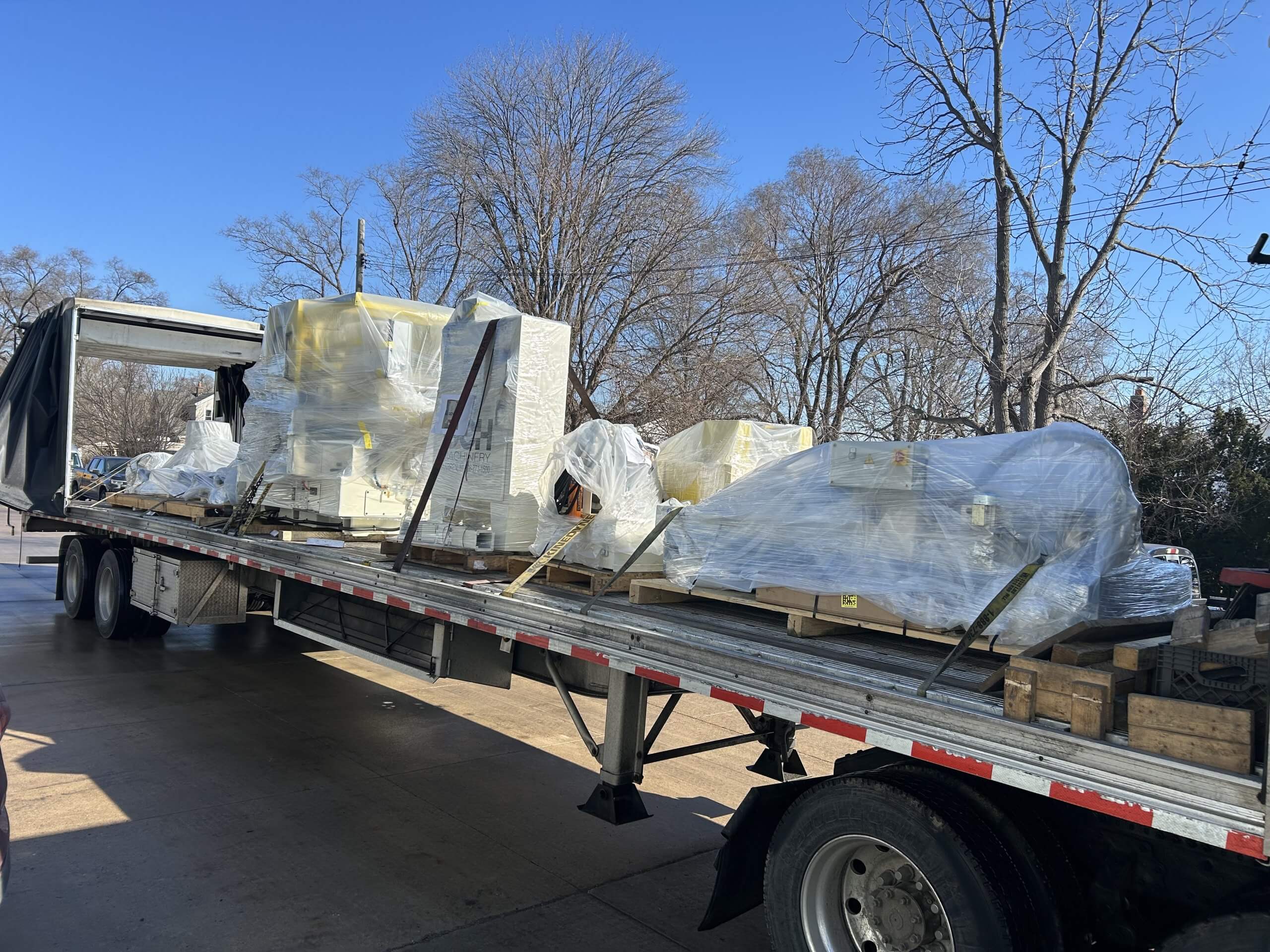 Conestoga flatbed trailer loaded with cnc machinery
