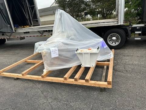 A robot secured on a skid being prepared for LTL shipping, demonstrating efficient freight handling for smaller shipments