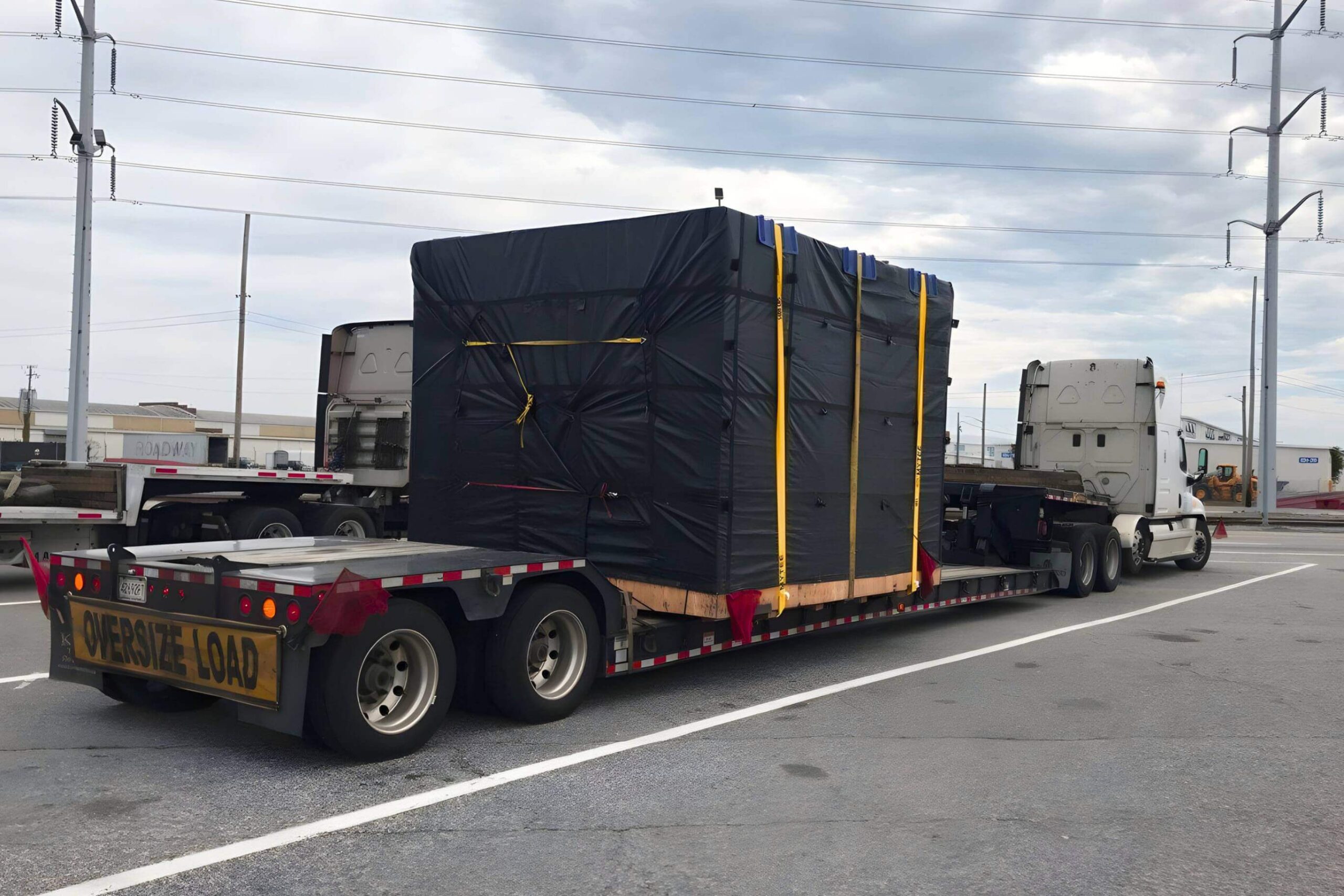 Full truckload freight service visual with a tarped double drop trailer loaded by Abound Transport