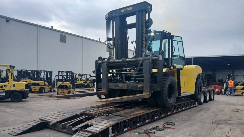 Hyster forklift secured on a heavy haul trailer for transport by Abound Transport.