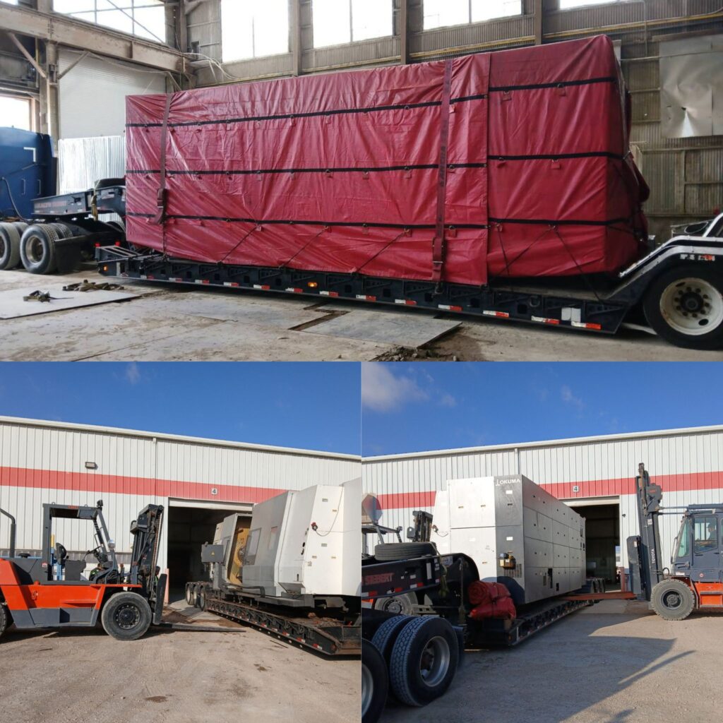 Oversized CNC machine being loaded and secured onto a double drop RGN trailer using forklifts, with the machine fully tarped for heavy haul transport.