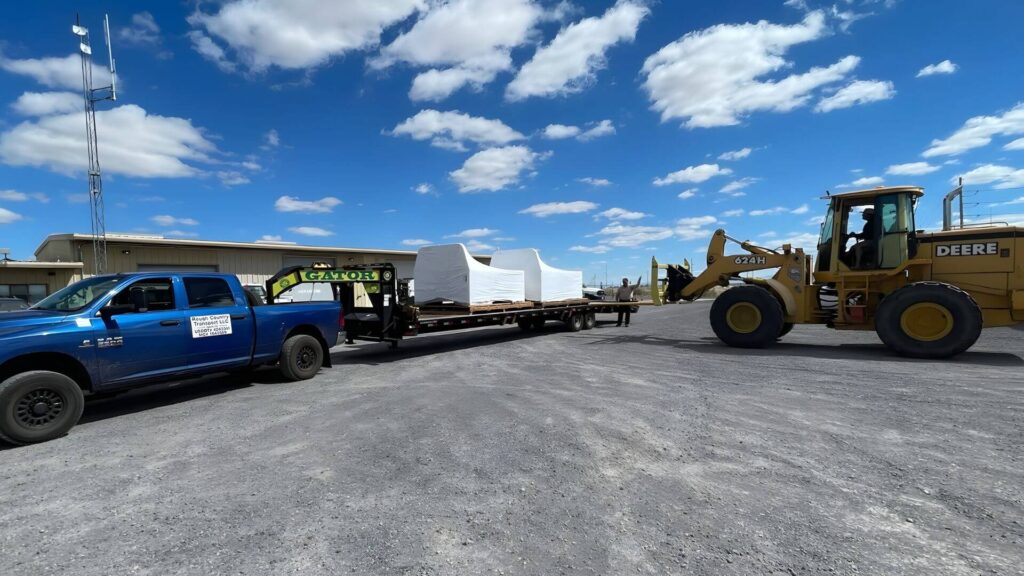 Expedited hotshot shipment to a jobsite for emergency shipment trailer being unloaded example of Abound transport expedite