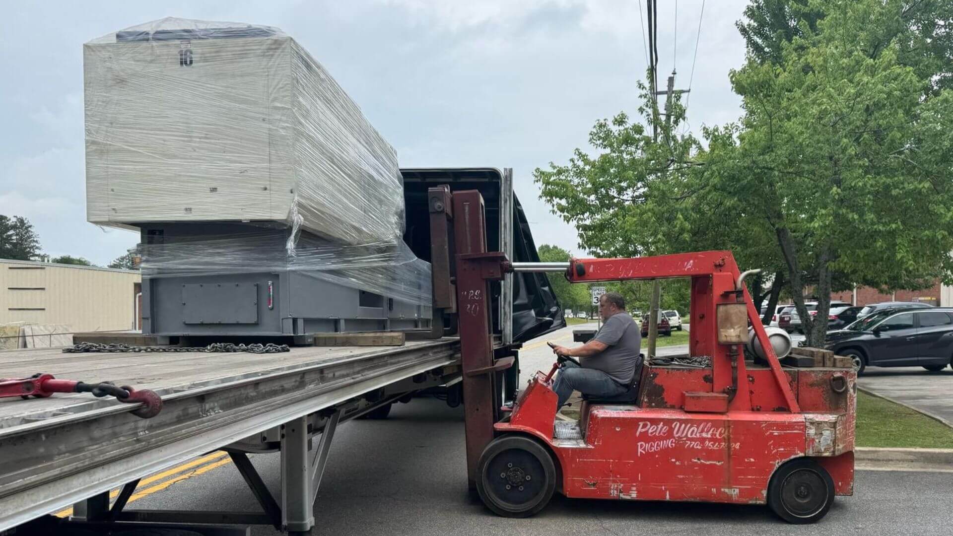 Rigging and unload of injection molding machine from Conestoga trailer