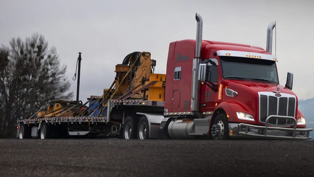 Full truckload step deck trailer hauling oversized freight across the United States with Abound Transport Group