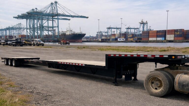 Extendable step deck stretch trailer loaded at port for oversized freight transport