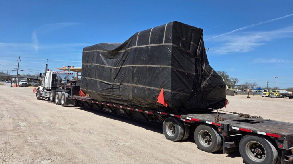 Tarped CNC machine, loaded by Abound Transport for long-haul, nationwide transport, including oversized and heavy haul.