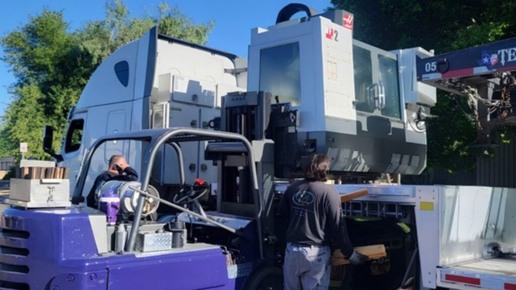CNC machining equipment loaded onto a trailer for transportation