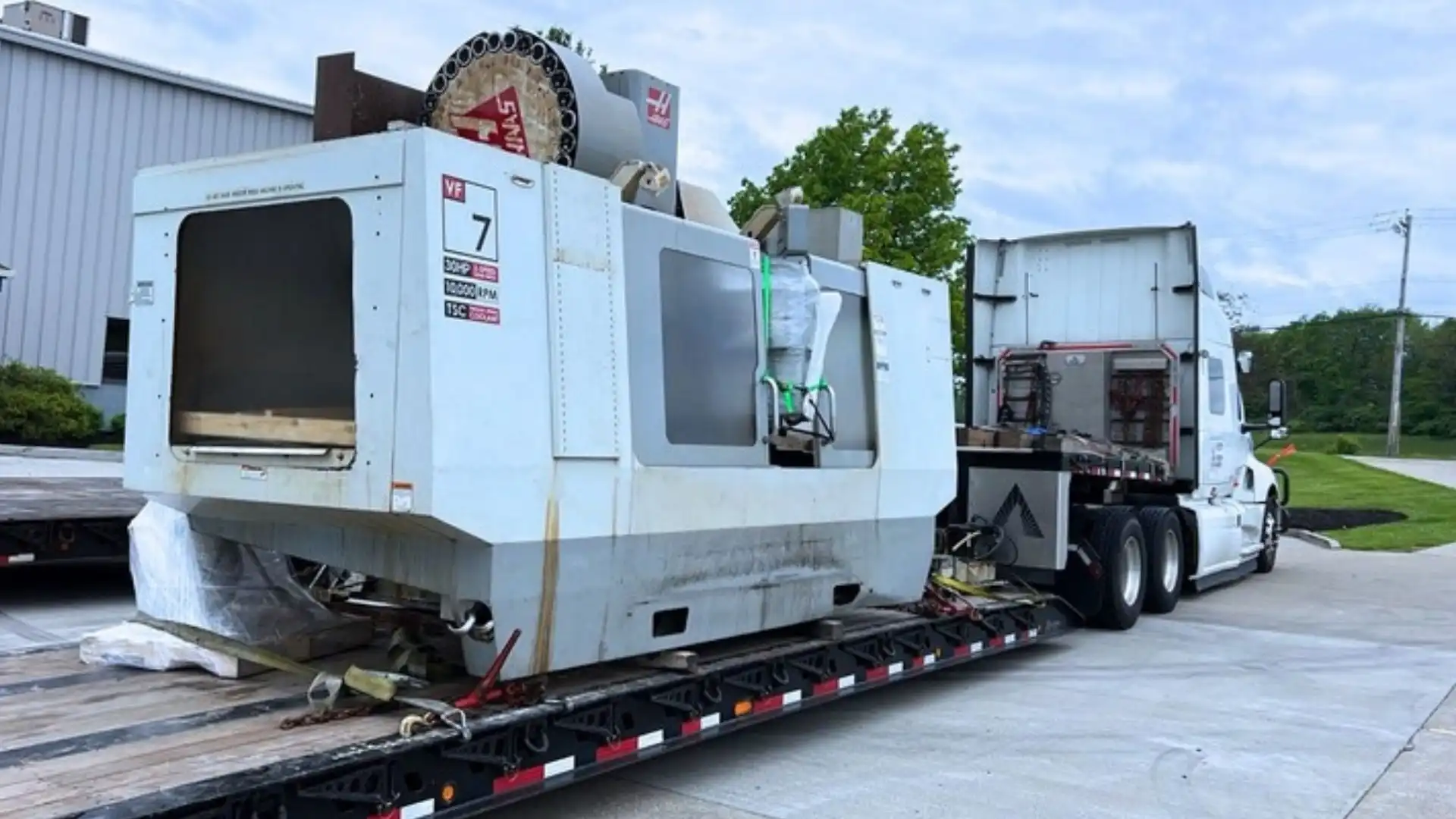 CNC machining equipment transported on a flatbed trailer