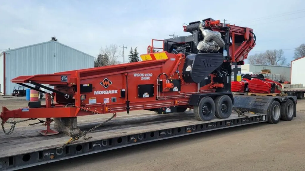 Morbark industrial grinding machine loaded on RGN trailer for heavy haul shipping