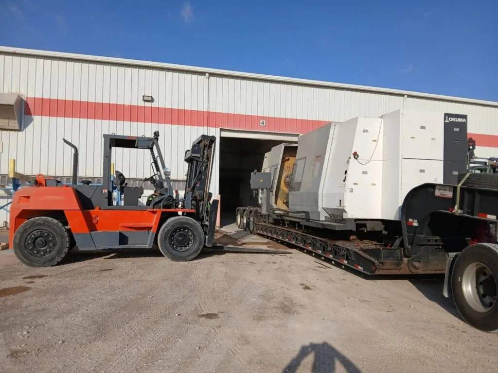 Rigging and unload of injection molding machine from Conestoga trailer