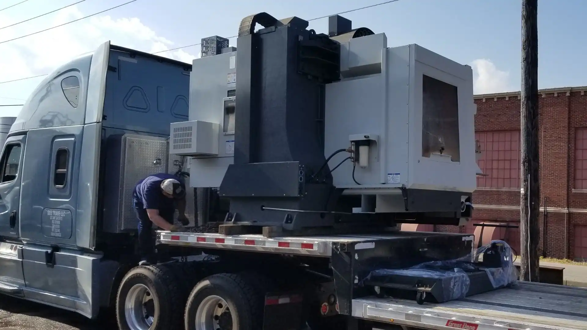 Horizontal CNC machining center on flatbed trailer partial truckload shipment Abound Transport