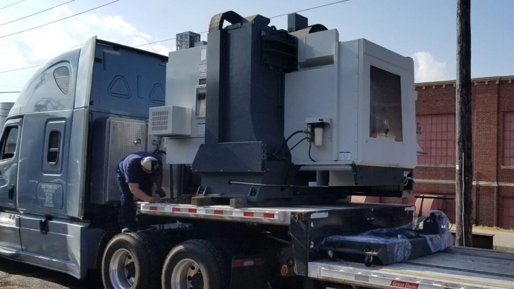 Horizontal CNC machining center on flatbed trailer partial truckload shipment Abound Transport