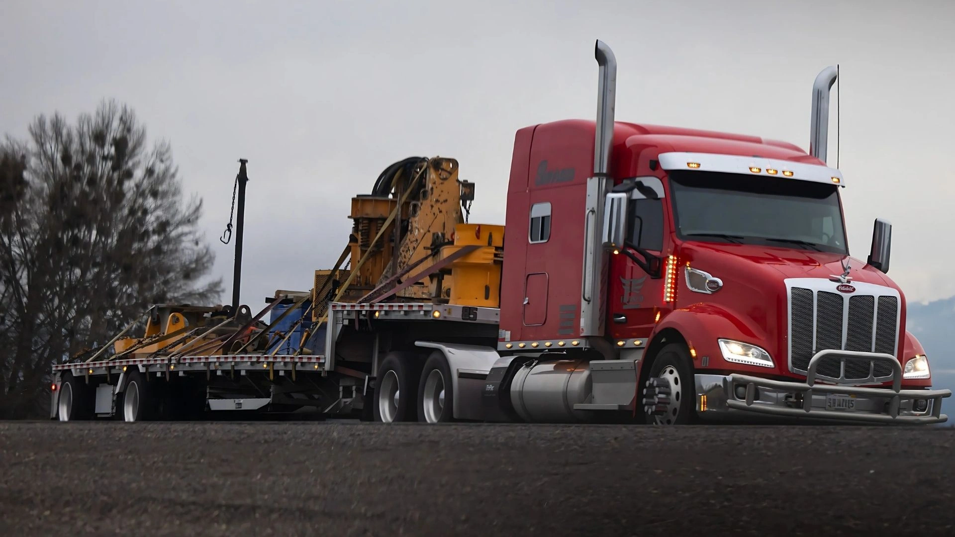 Full truckload step deck trailer hauling oversized freight across the United States with Abound Transport Group