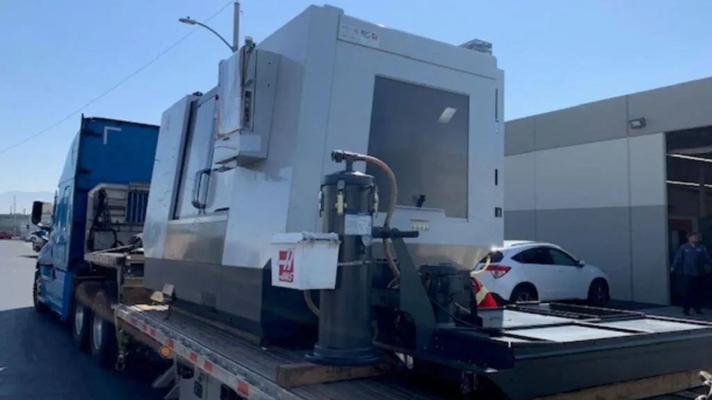 haas vf-4 cnc machine loaded on a stepdeck trailer secured and loaded example by abound transport