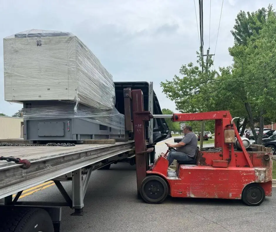 Rigging and unload of injection molding machine from Conestoga trailer