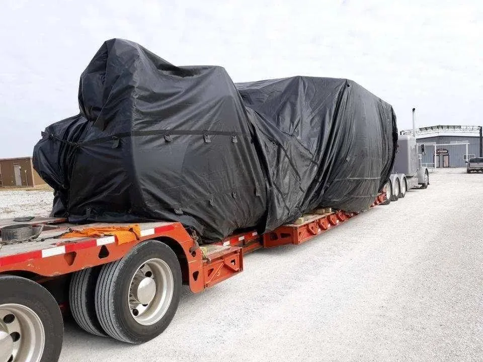 880 ton injection molding machine tarped on a double drop trailer