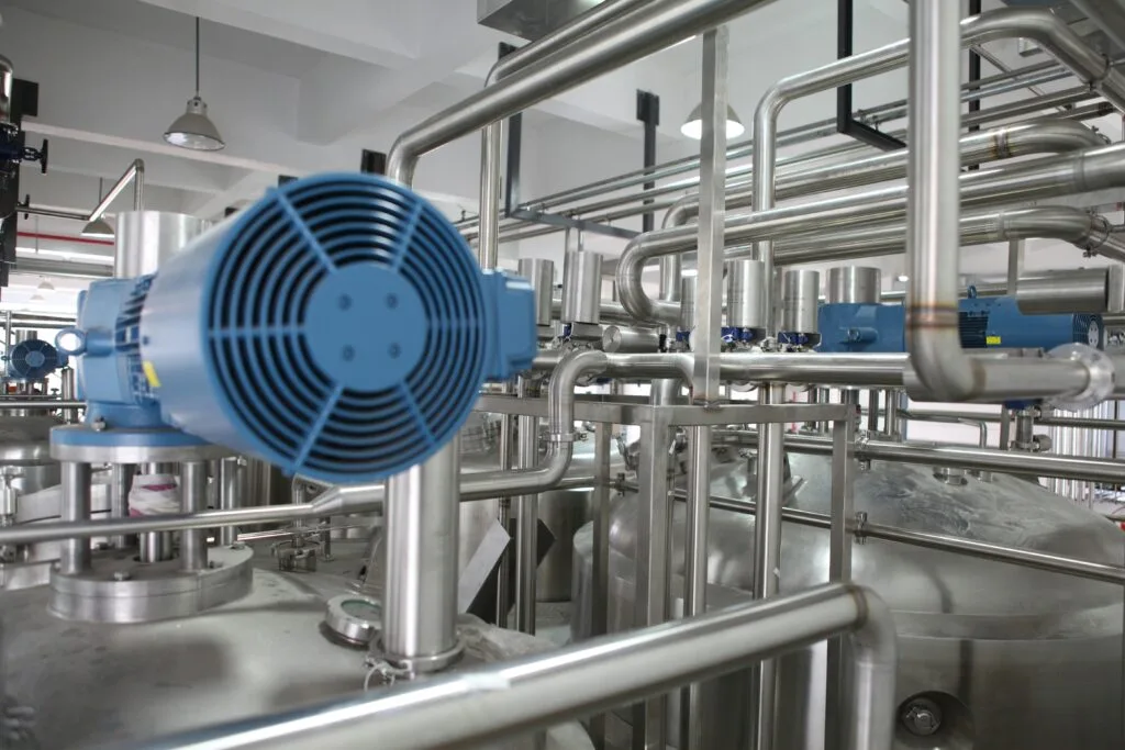 Industrial stainless steel piping network and processing tanks with agitator motors