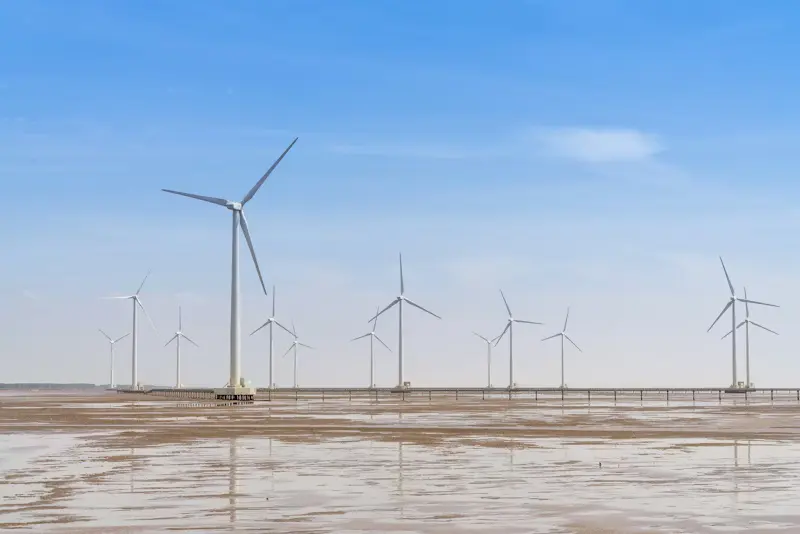 Offshore wind turbines in coastal tidal flats generating renewable energy