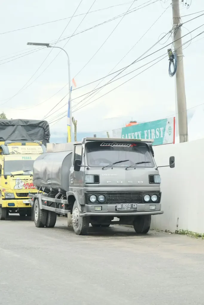 Mitsubishi Fuso commercial tanker truck transporting liquid freight parked along a street