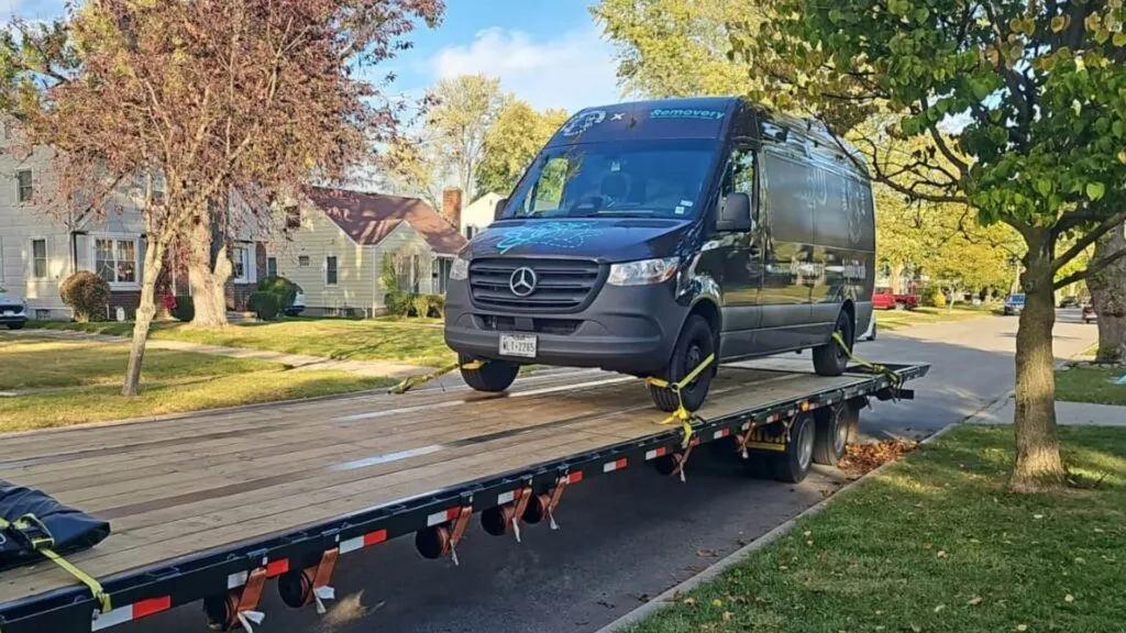 sprinter van loaded on a hotshot with ramps for cross country transport door to door service abound transport