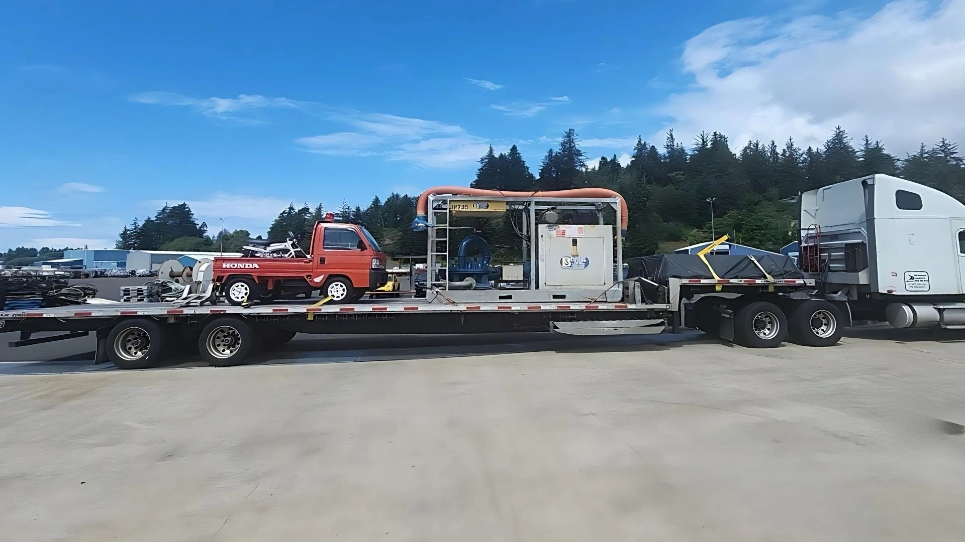 Industrial generator loaded on low profile step deck trailer for partial truckload shipping by Abound DeckShare